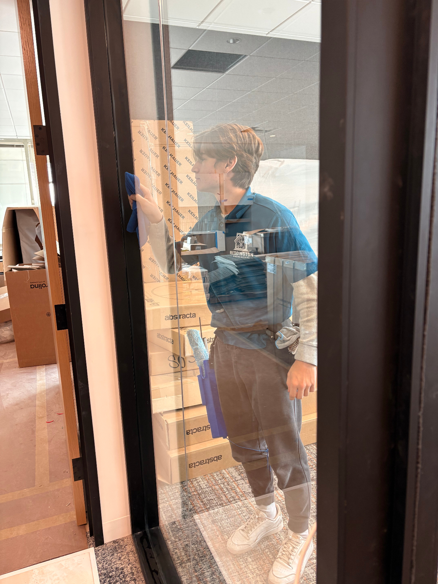 Nelson cleaning a glass door